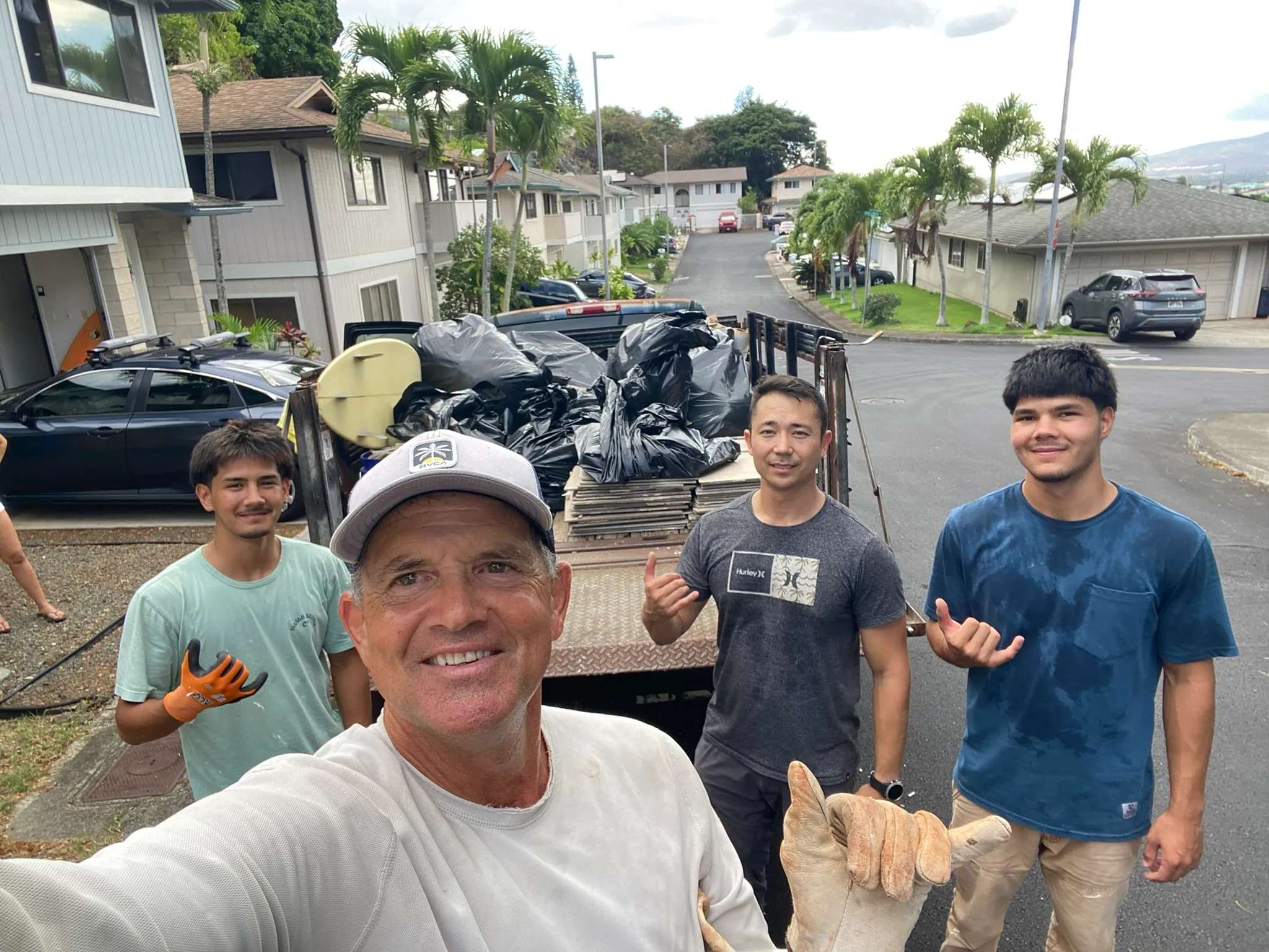 JunkForce team and company vehicle loaded with garbage